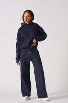 A model wearing the navy wide-leg joggers for women with a matching hoodie.