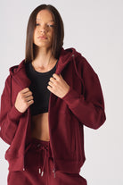 Front view of the women's red zip-up hoodie.