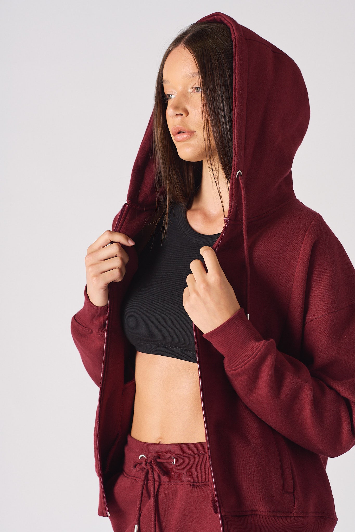Angled close-up of the women's red zip-up hoodie.