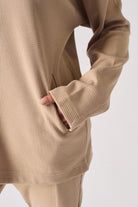 Detailed texture view of the soft brushback fabric on beige jumper