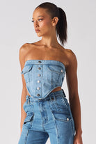 A model styled in the strapless light blue wash denim corset with matching jeans.