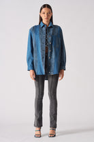 A model showing how to style the blue acid wash denim shirt.