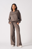 A model showing how to style the women's baggy joggers in brown.