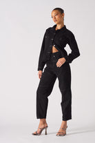 Angled side view of the tapered denim waist jacket.