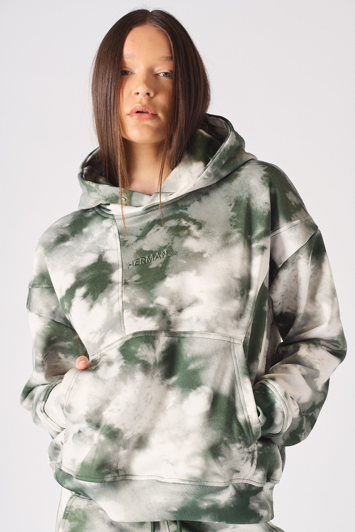 Side angle view showing the relaxed fit of the womens tie dye dark green hoodie