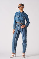 A model wearing the two-tone distressed denim crop jacket with matching jeans.