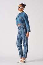 Side profile of a model in the two-toned denim jacket and jeans set.
