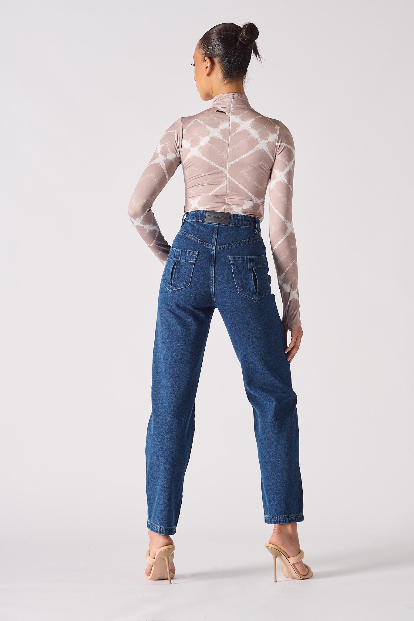 Back view of a model wearing the whisker jeans for women.