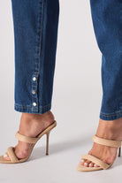 Detailed view of the popper button hem on the whisker jeans for women.