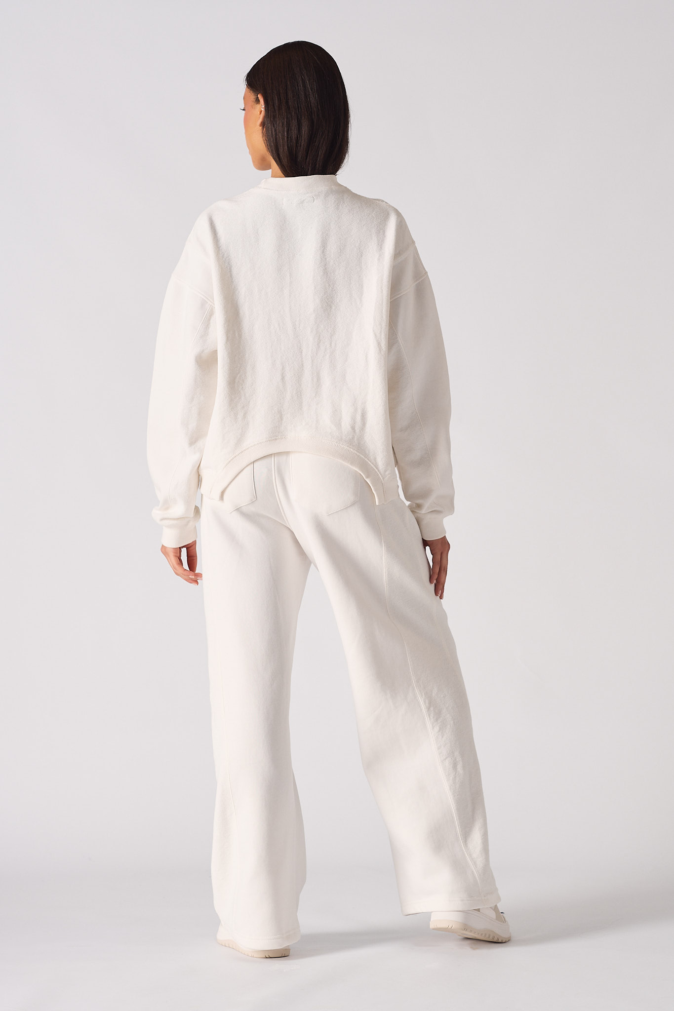 Rear view showing the relaxed fit of the white crew neck jumper for women