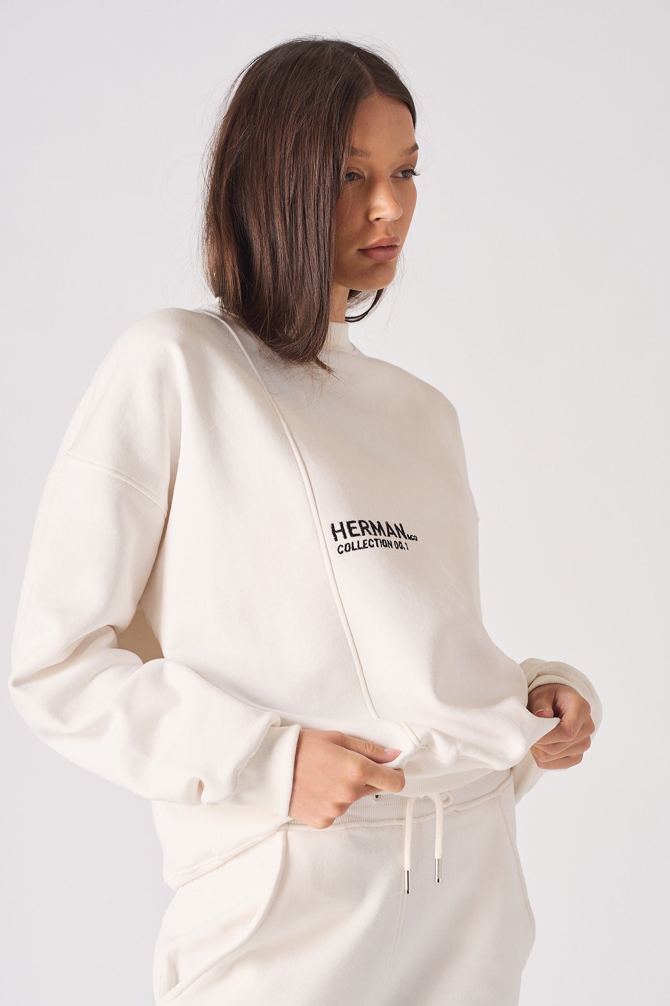 Close up detail of the bold HERMAN logo on the back of the sweatshirt