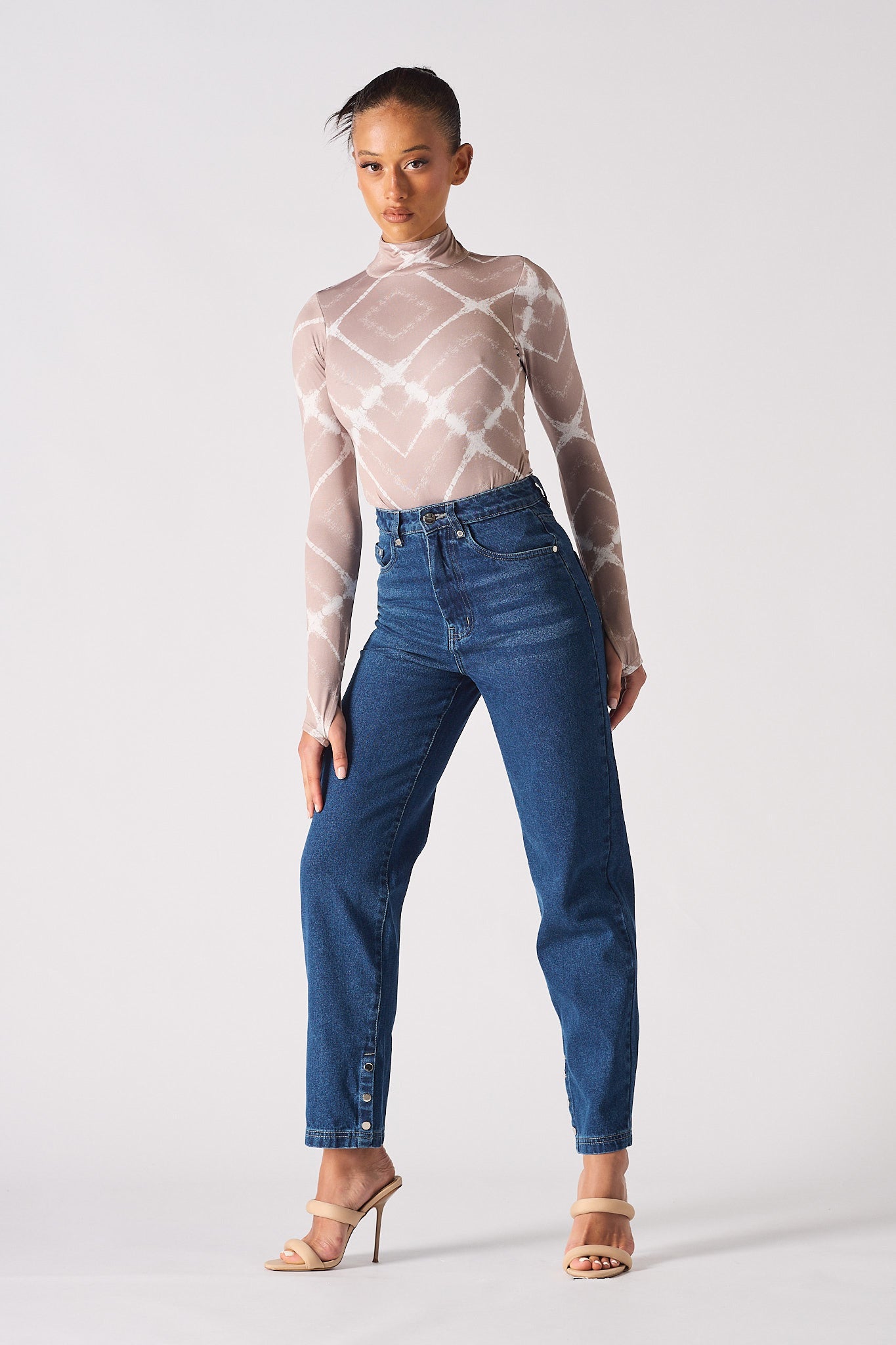 A model styled in the women's dark wash whisker jeans.