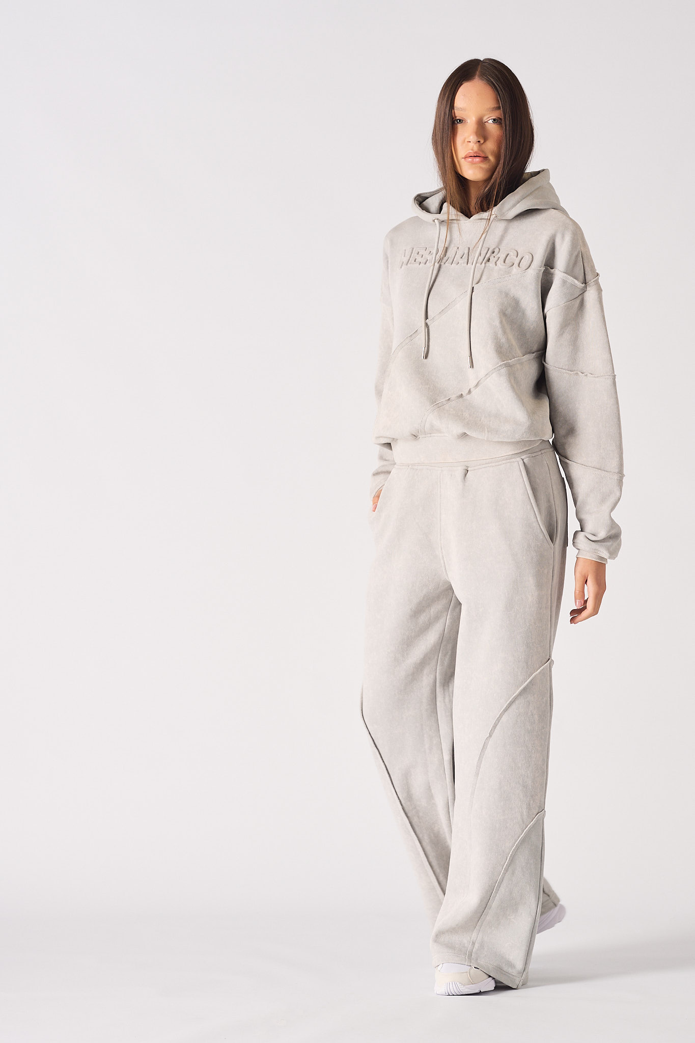 Full view of a model styled in the women's grey oversized joggers and hoodie.