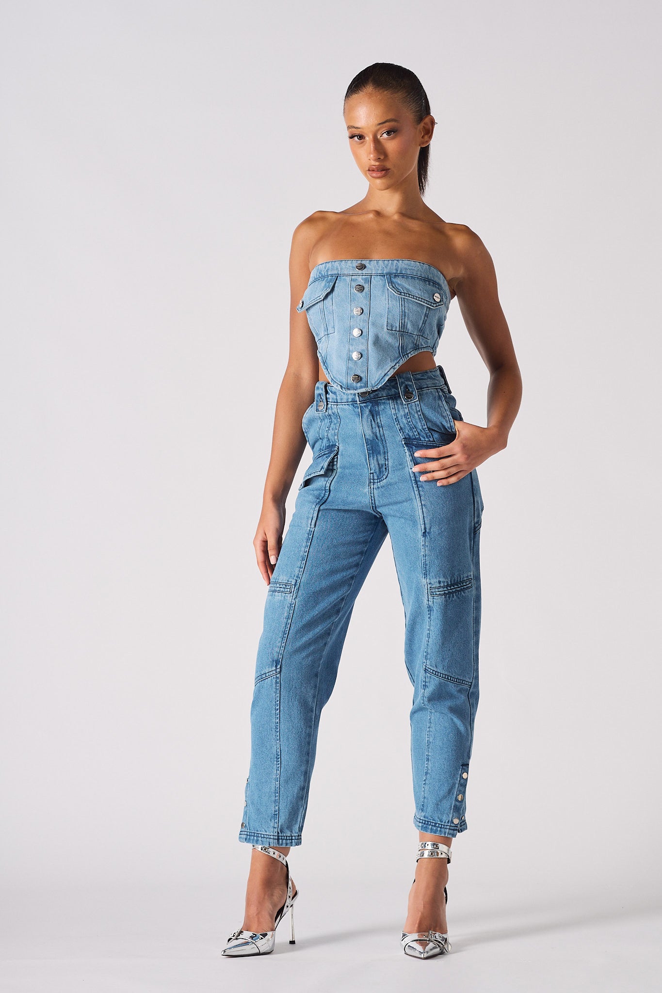 Full front view of a model wearing the women's mid-wash cargo jeans.