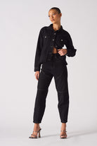 A model showing a full look with the women's tapered denim jacket.