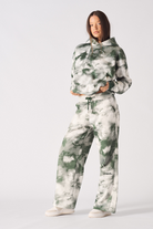 A model wearing the full women's green and white tie-dye tracksuit set.