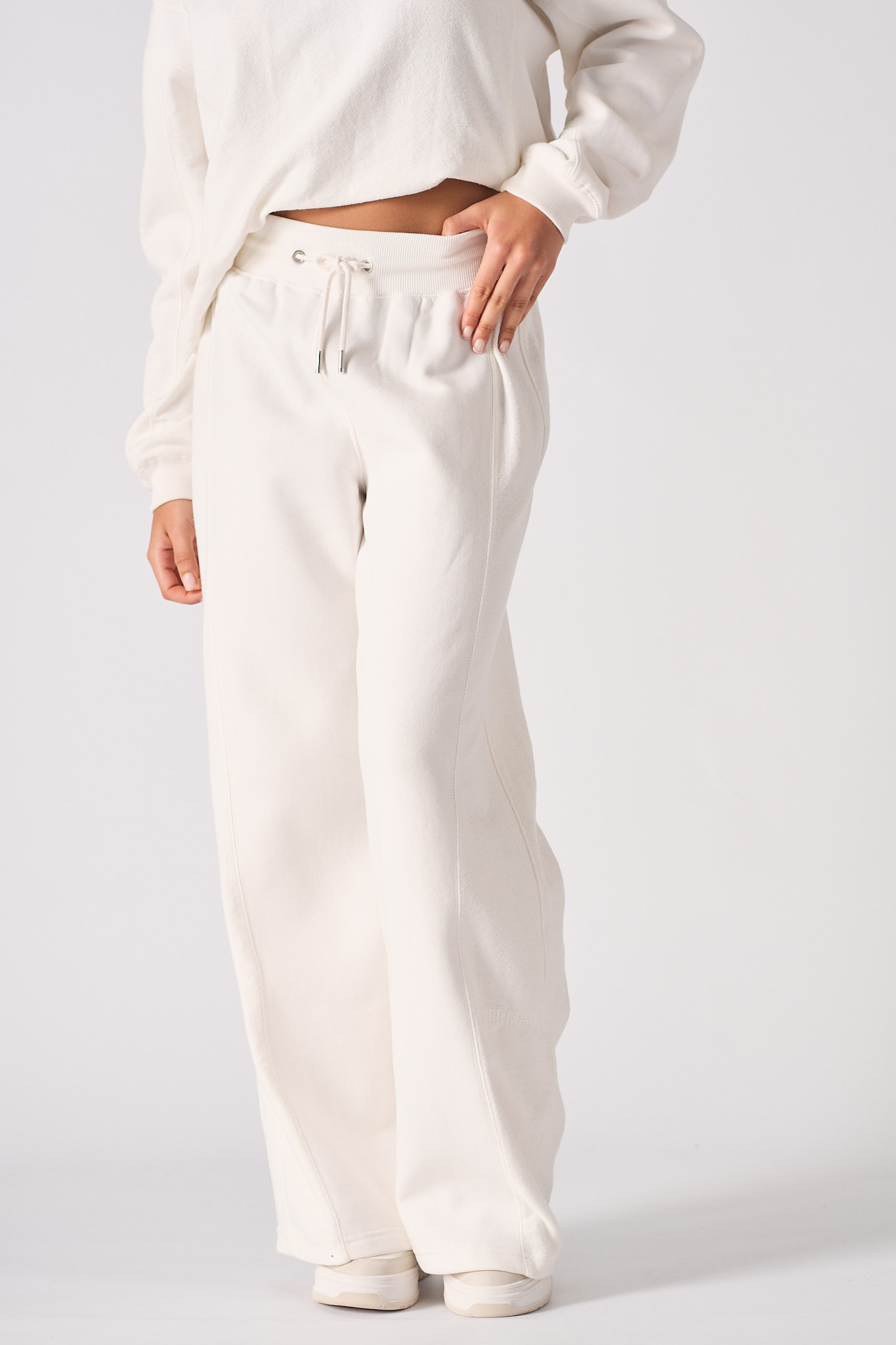 Front close-up of the women's white joggers with a wide-leg cut.