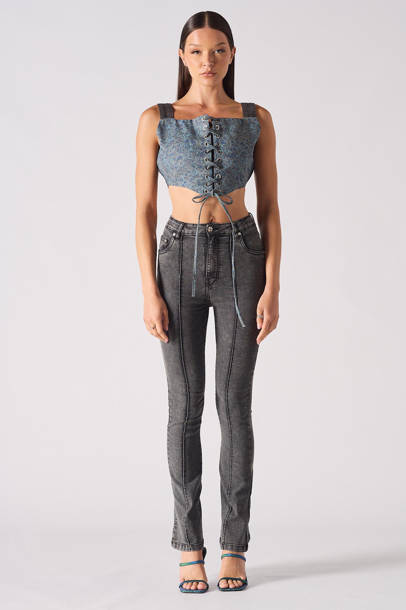 Full front view of a model styled in the women's acid grey flare jeans.