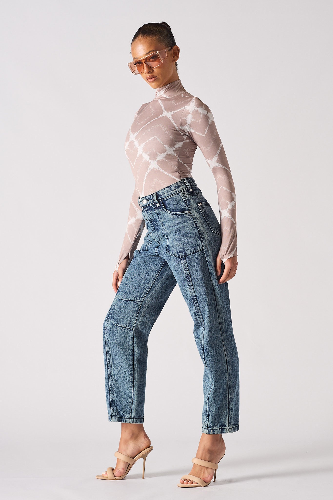 Side profile of a model wearing the women's acid wash mom jeans.