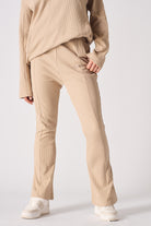 Detailed front view of the women's beige flare joggers with seam detailing