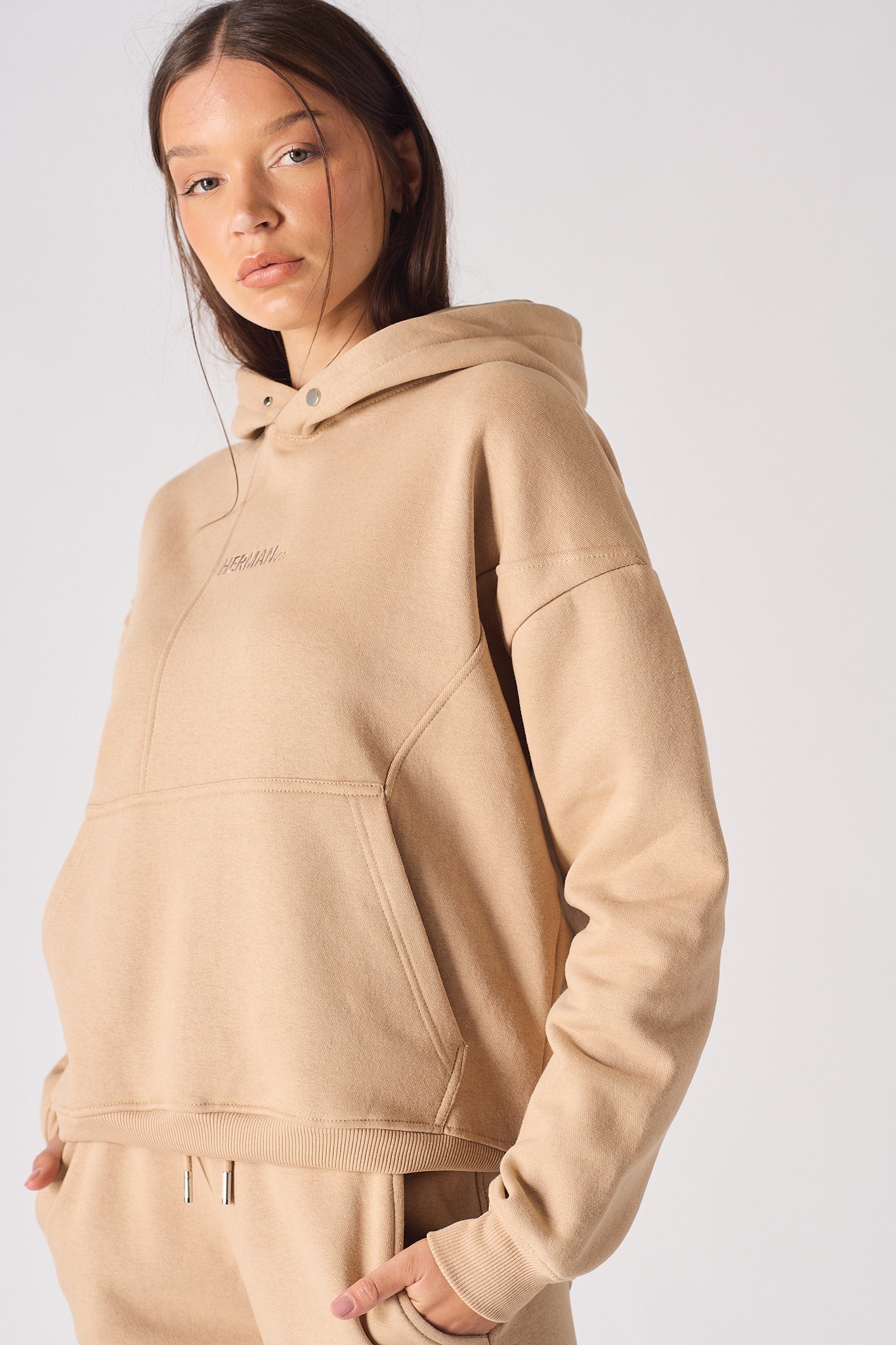 Close up detail of the hood and neckline on womens beige pullover