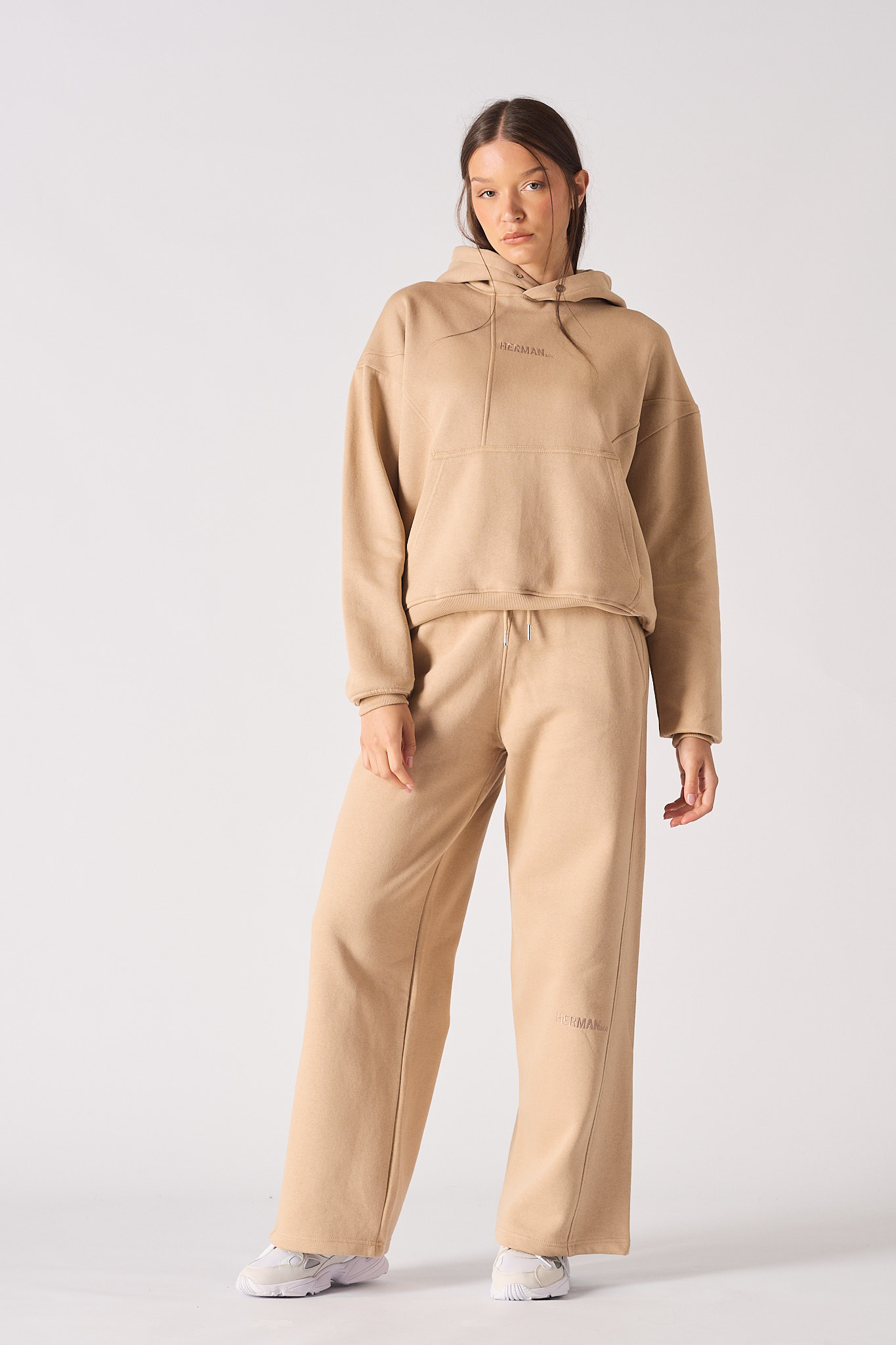 Front view of model wearing womens beige hoodie with matching wide leg joggers