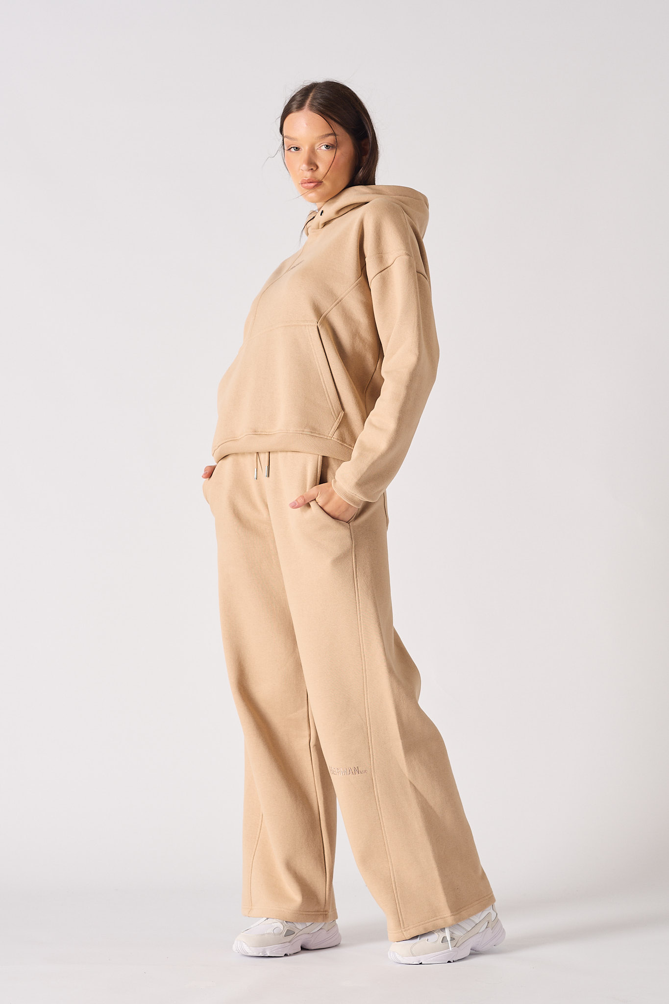 Side profile view showing the loose fit of the womens beige hoodie