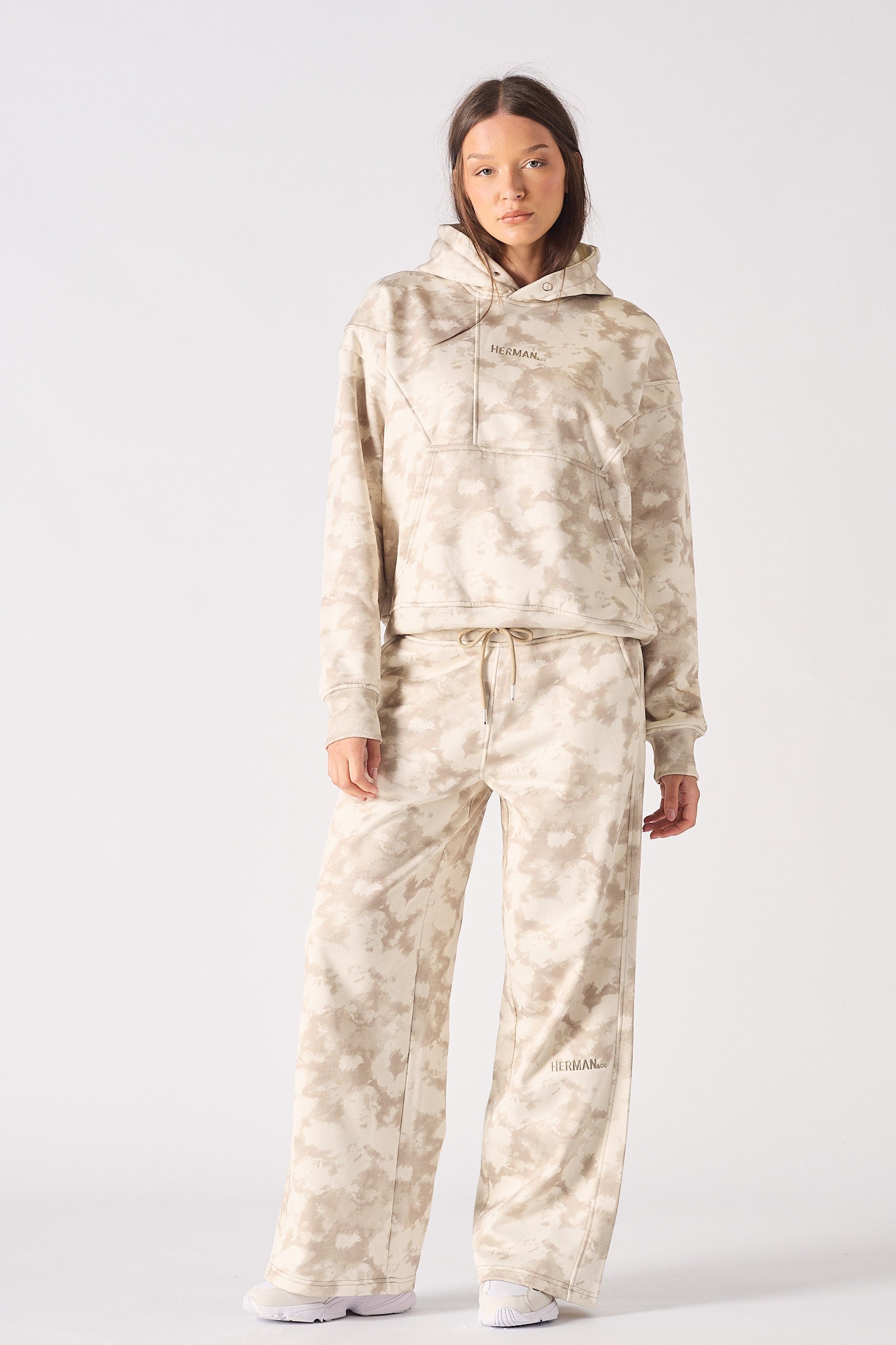 Flat lay front view of essential womens beige tie dye hoodie with kangaroo pocket