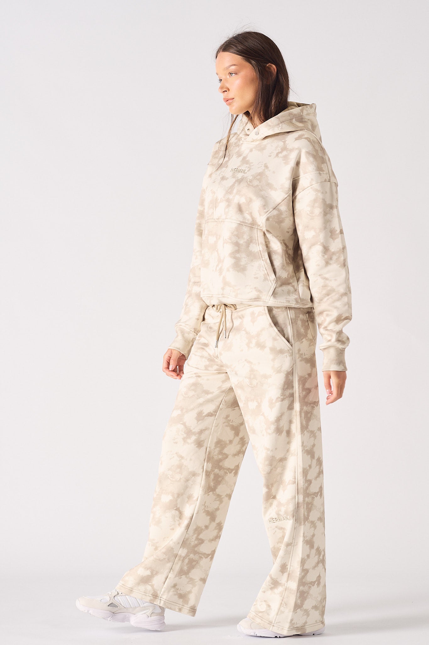 Front view of model wearing womens beige tie dye hoodie with matching wide leg joggers