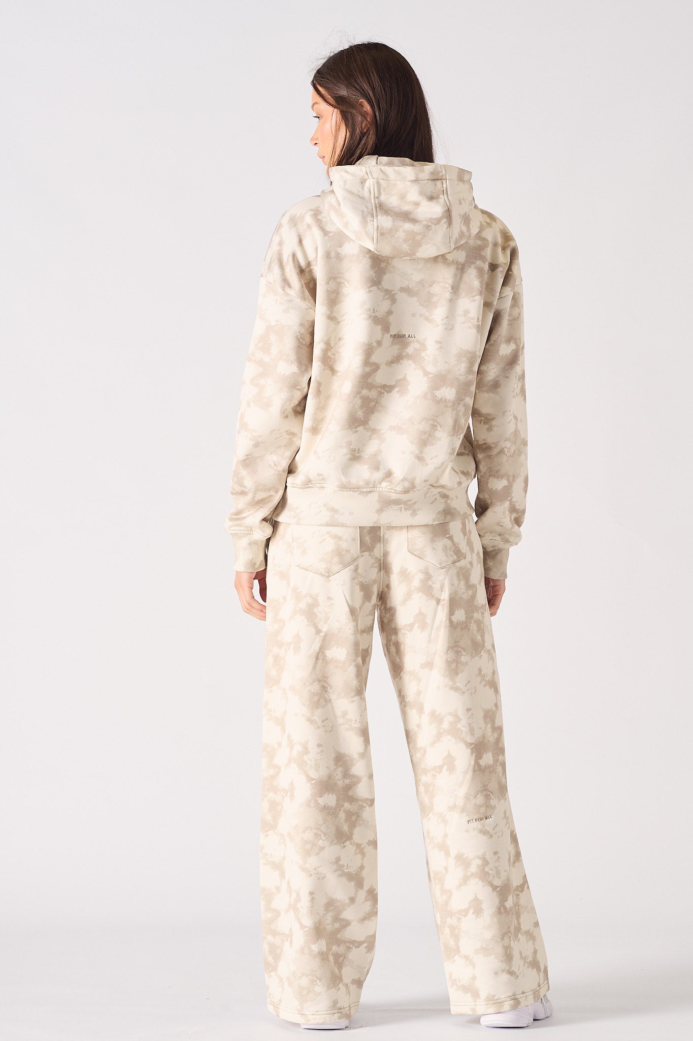 Flat lay front view of stylish beige tie dye wide leg joggers