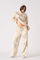 Front view of model wearing beige tie dye wide leg joggers with matching hoodie