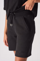 Flat lay front view of essential womens black fleece shorts