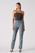 Full front view of a model wearing the women's black distressed corset top.