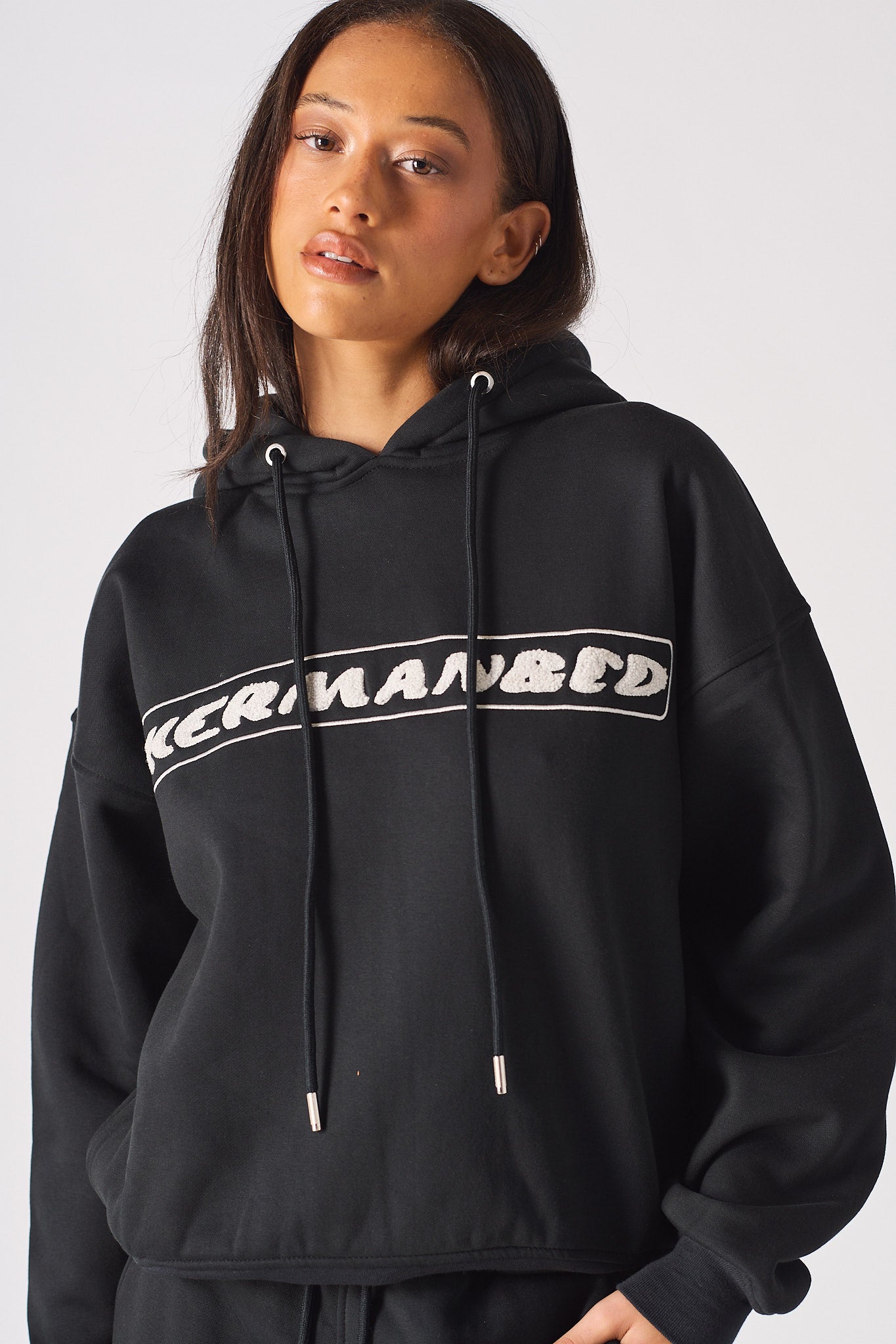 Rear angle view showing the hood structure on black oversized hoodie