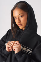 Detailed view of the ribbed hemline on black oversized hoodie womens