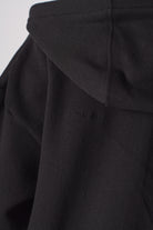 Close up detail of the hood structure on black zip up hoodies for women