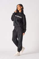 Close up detail of the ribbed sleeve cuff on womens black oversized hoodie