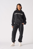 Model posing in a casual streetwear style wearing black oversized hoodie womens