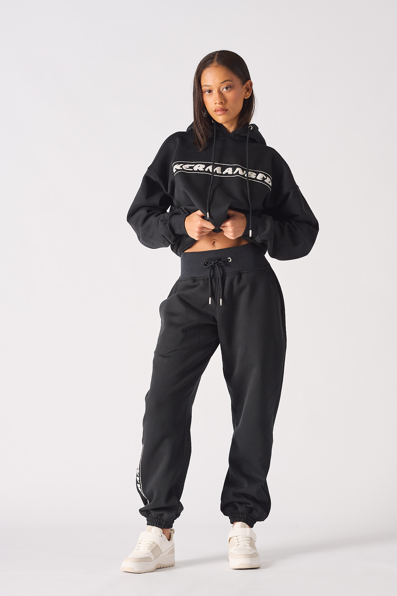 Full length view of model wearing black oversized joggers womens with matching hoodie