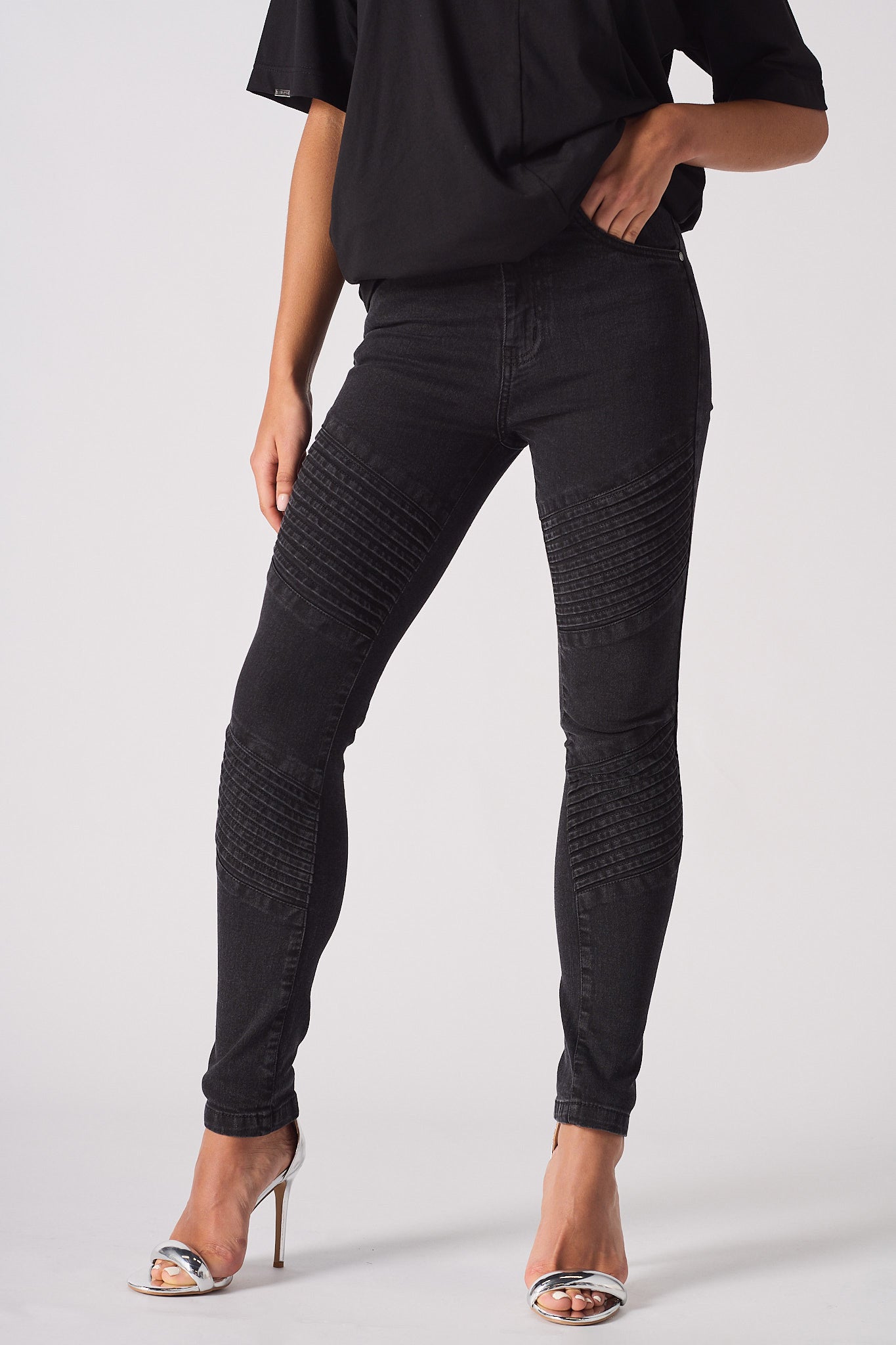 Front close-up of the women's black skinny biker jeans showing the ribbed knee detail.