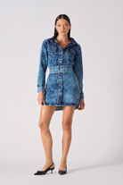 Front view of a model wearing the women's blue acid wash denim dress
