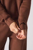 Flat lay front view of the essential brown crew neck jumper womens