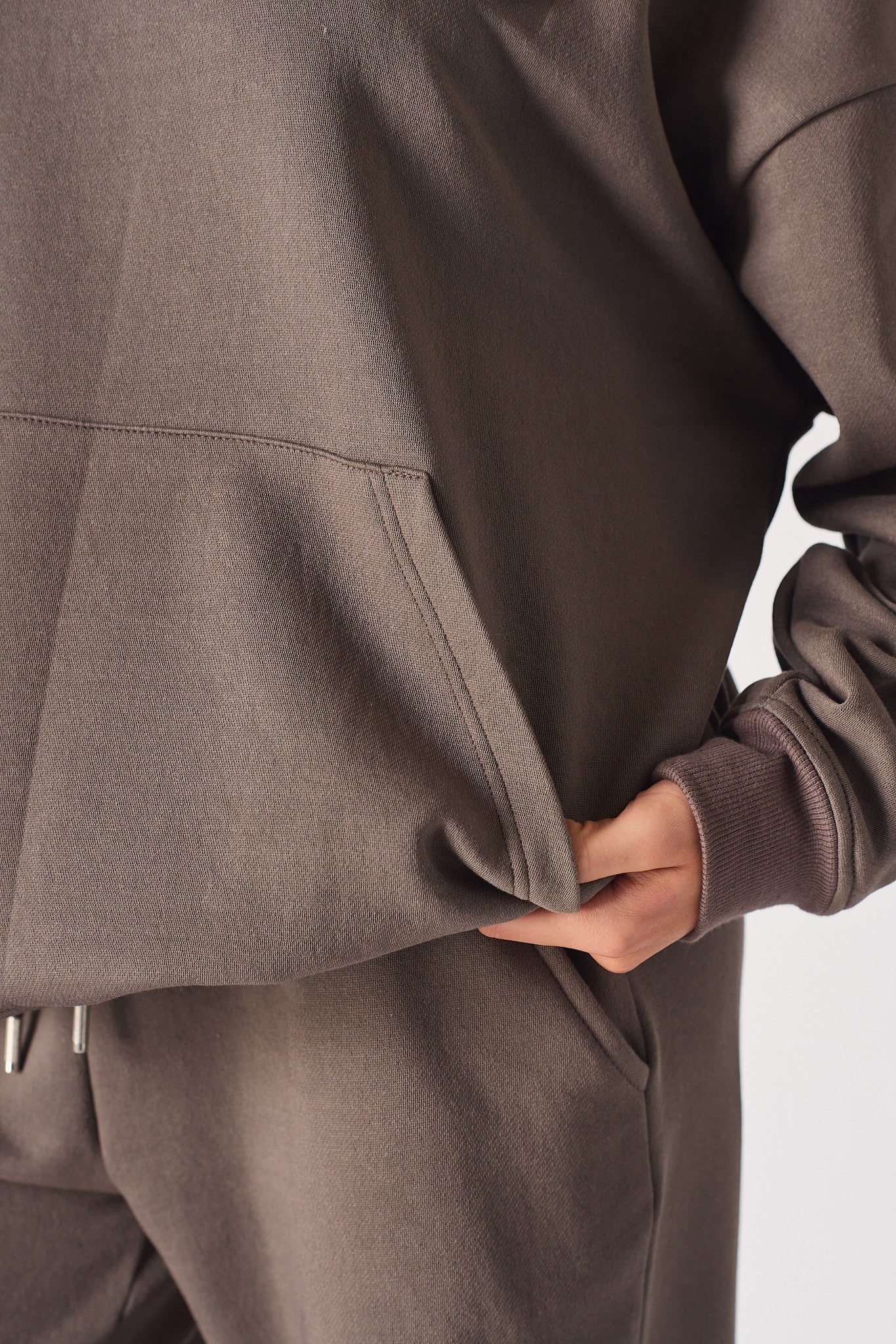 Detailed close up of the collar and zip on brown half zip women's sweatshirt