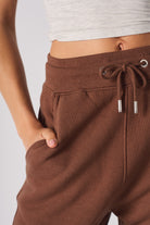 Close-up of the drawstring waist and side pocket on the women's brown joggers.