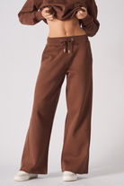 Close-up of the women's brown wide-leg joggers showing the relaxed fit.