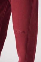 Detailed view of the ribbed ankle cuff on womens burgundy joggers