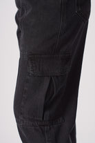 Detailed view of the side cargo pocket on the women's jeans.