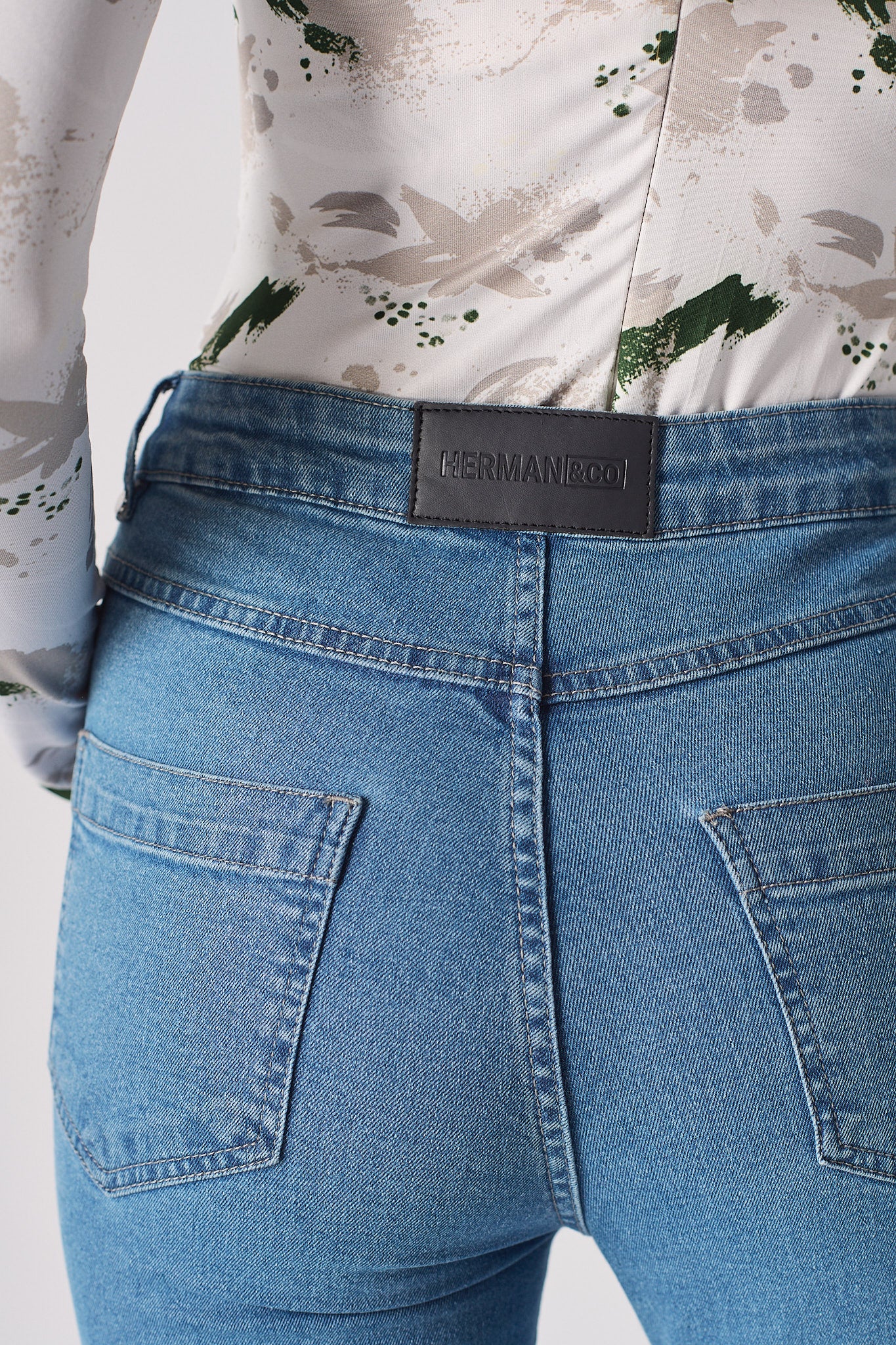 Back view of the women's contrast mid-blue skinny jean laid flat.