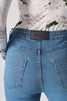 Back view of the women's contrast mid-blue skinny jean laid flat.