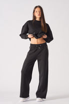 Full length view of model wearing black contrast stitch jogger with matching hoodie